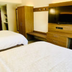 guest room with two queen beds and deluxe in-room amenities